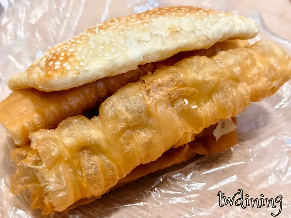 經典的 clay oven rolls 燒餅夾油條 fried bread stick 是永和四海豆漿北平店必吃，酥脆燒餅撒上 sesame 芝麻搭配 crispy texture 油條，這份 traditional breakfast 飽足感十足。